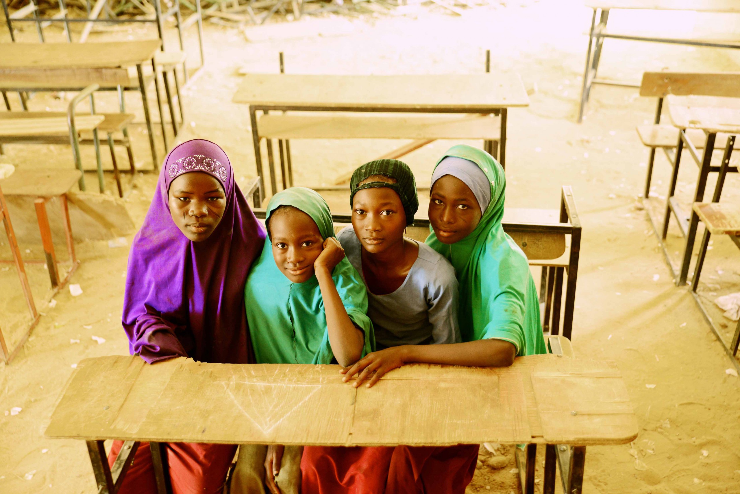 - Nutrition International Four girls seating in a classroom in Niger Sud Dogo