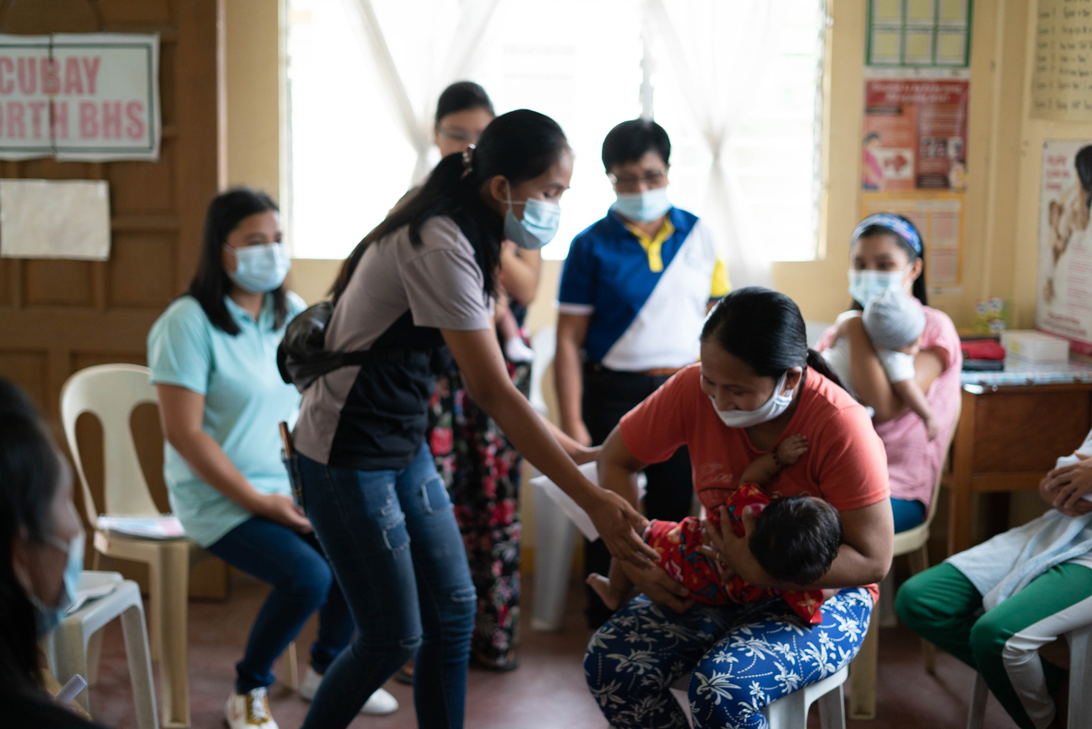 Philippines_BF1KD_DSC0514 - Nutrition International A mother demonstrates different holds for breastfeeding during a peer support group in the Philippines