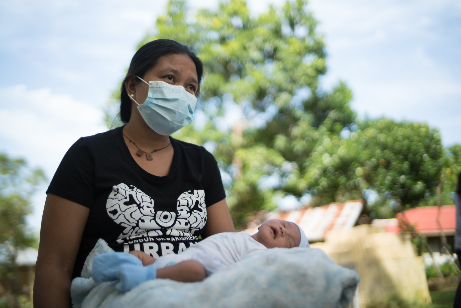 Philippines_BF1KD_DSC08304 - Nutrition International Mother wearing a mask holds her baby