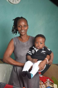 Kenya_Busia_Joy Elizabeth_IMG-20210721-WA0006 - Nutrition International Mom holding her son smiling to camera