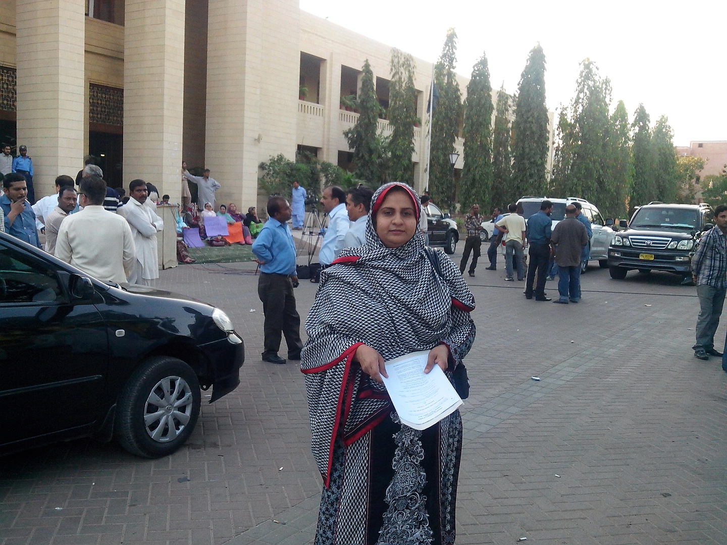 Pakistan_Fatima Saad_IMG_20130314_175434 - Nutrition International Nutrition International staff member Fatima Saad standing in front of a building in Pakistan
