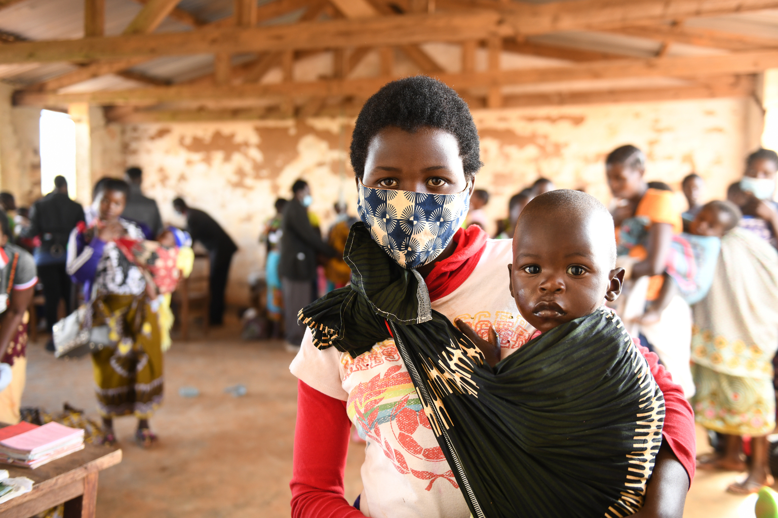 DSC_6541 - Nutrition International A mother wears a mask while taking her child to an under-5 health clinic in Malawi