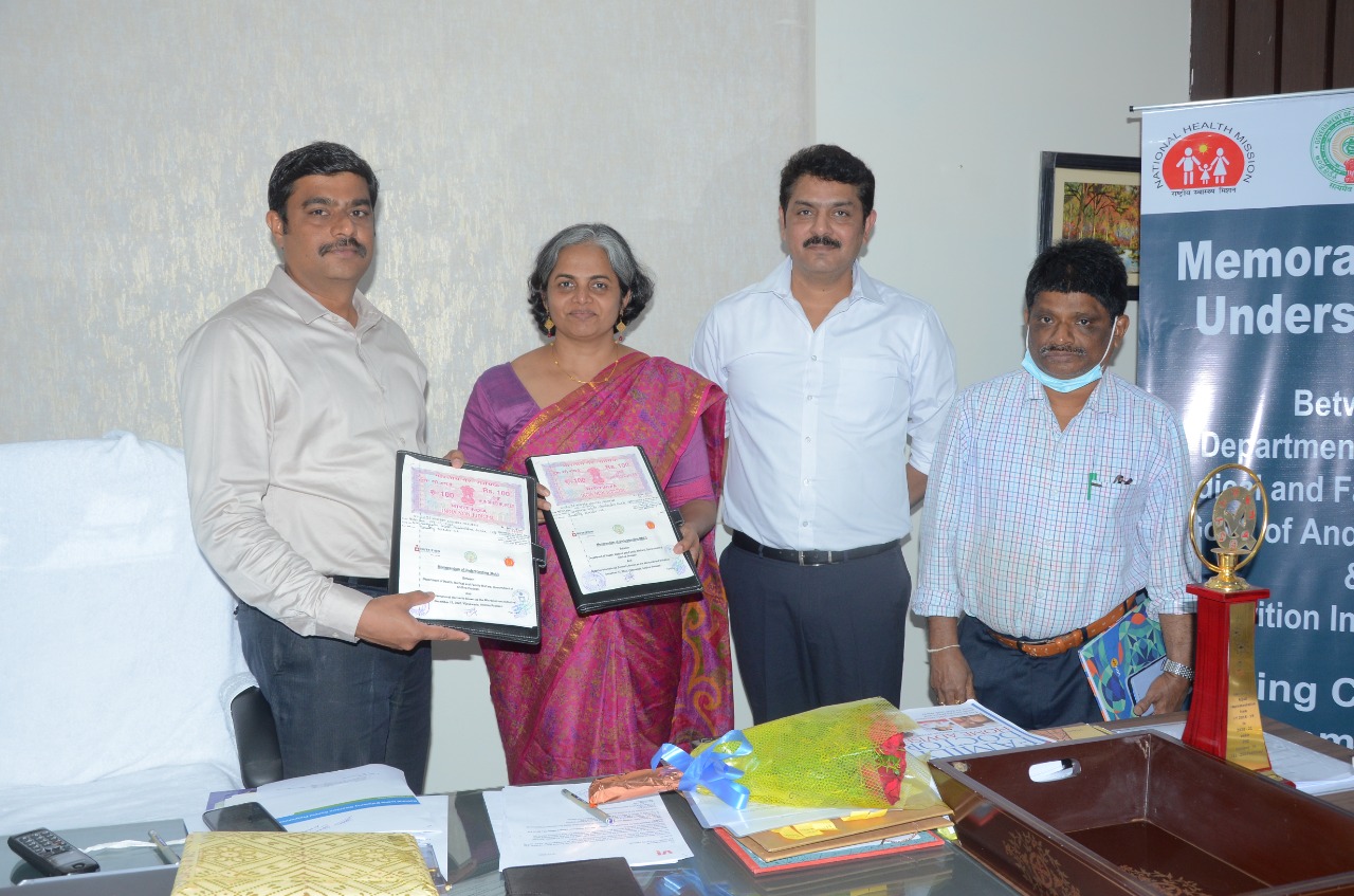 Group of people facing the camera holding the memorandum of understanding