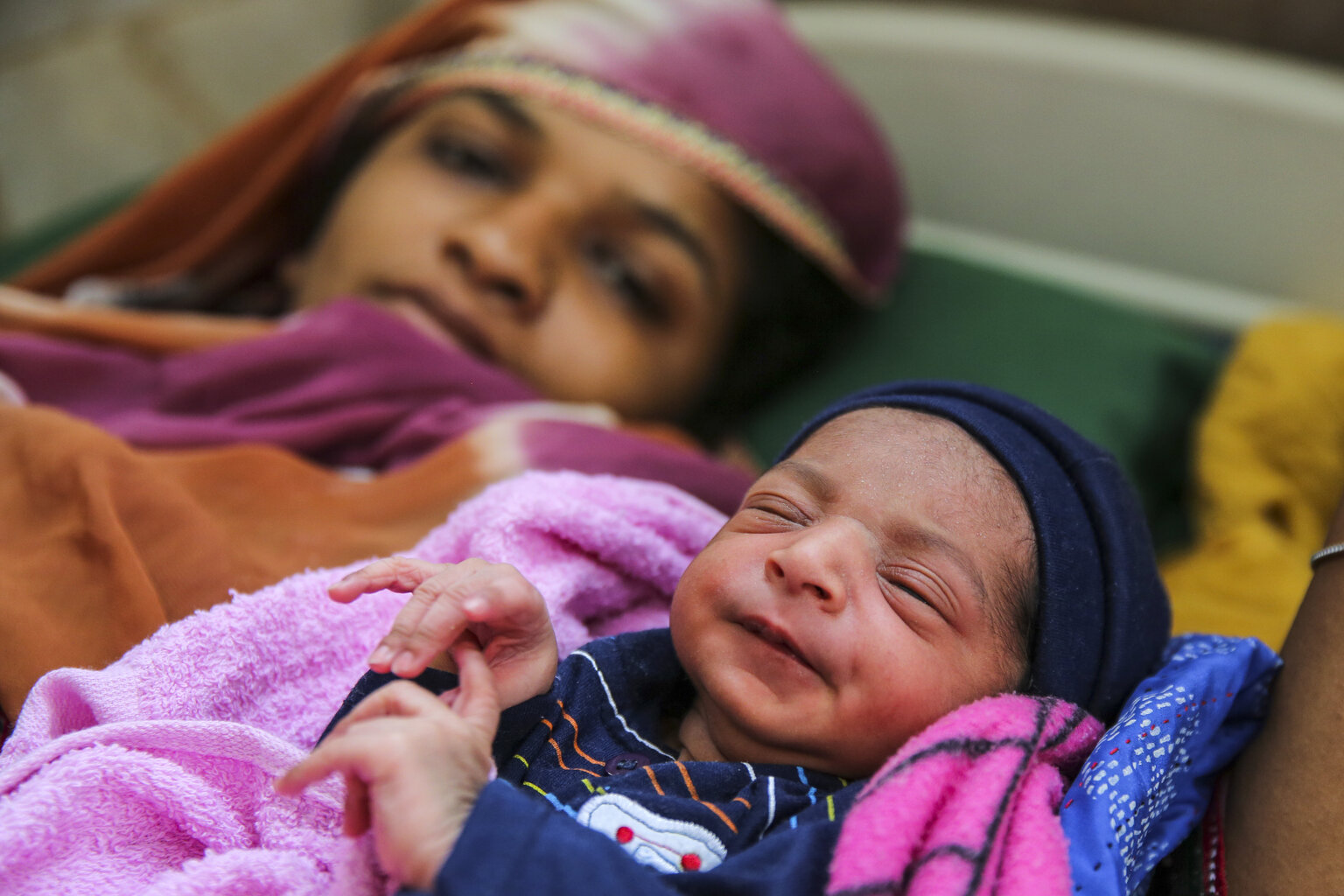 A mother and baby lying on their backs