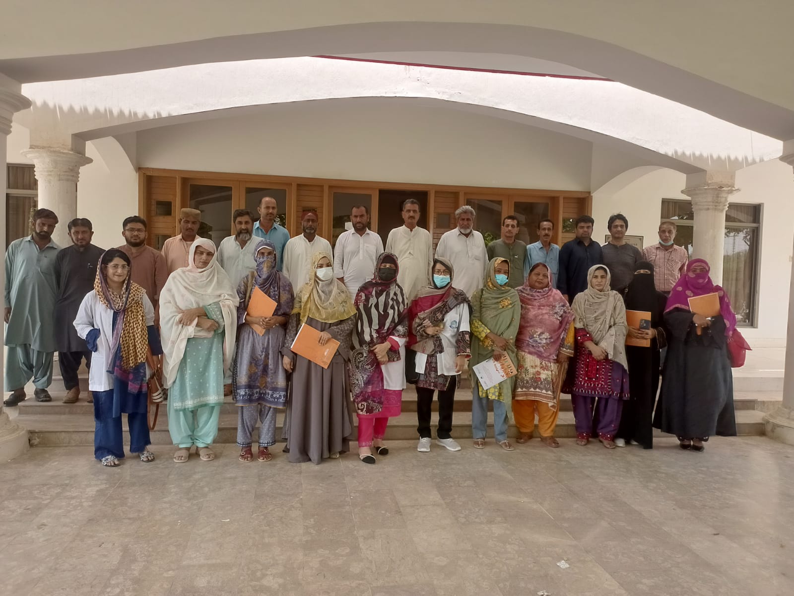 A group of health workers listen during a training on the use of zinc and LO-ORS to treat childhood diarrhoea in Pakistan.